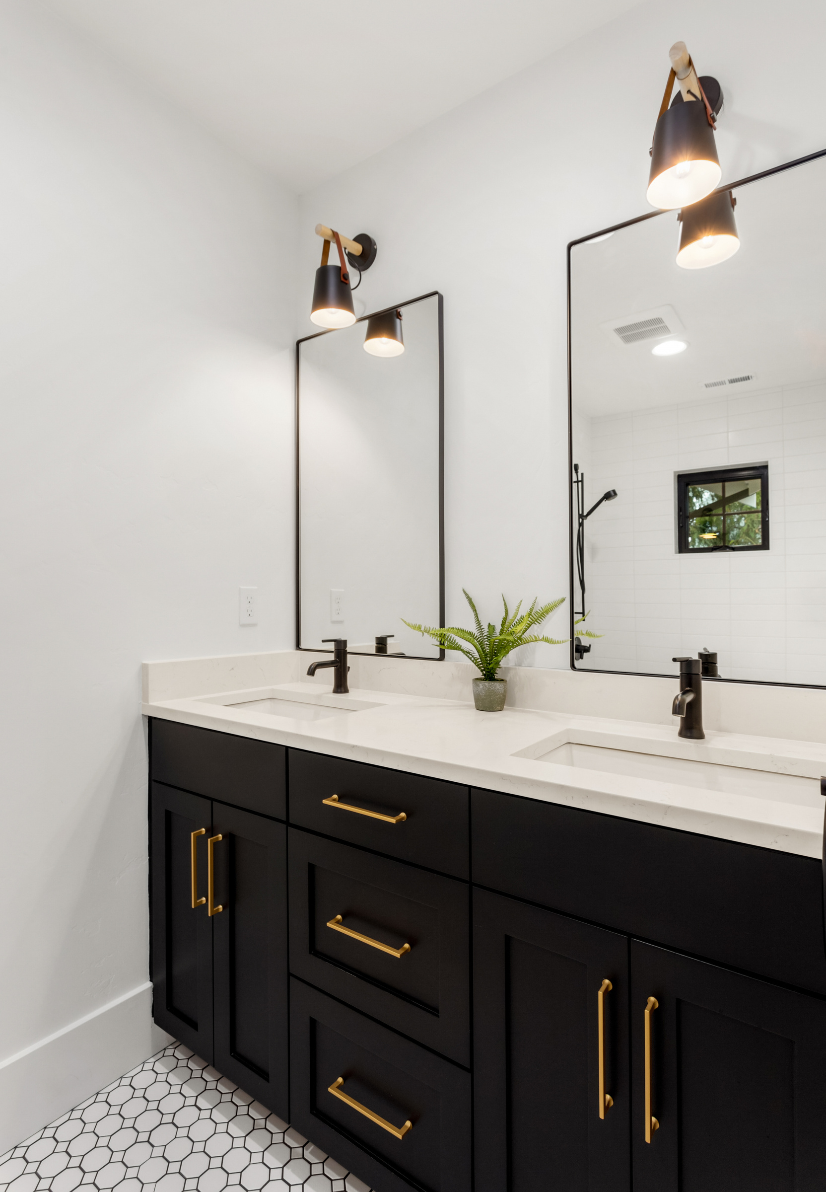 Beautiful bathroom interior in new luxury home with vanity, mirror, and cabinets